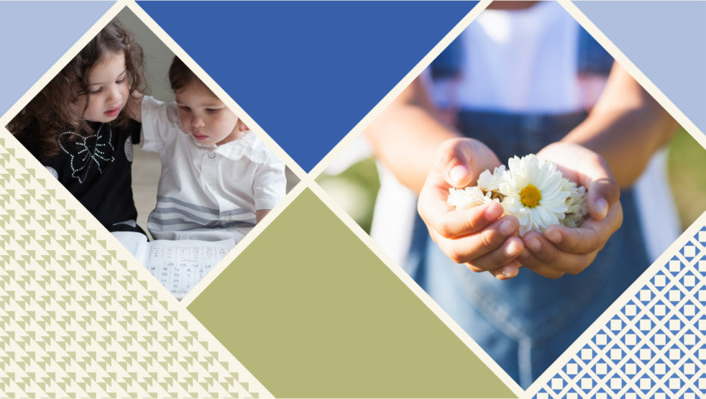 two little girls reading and one holding flowers