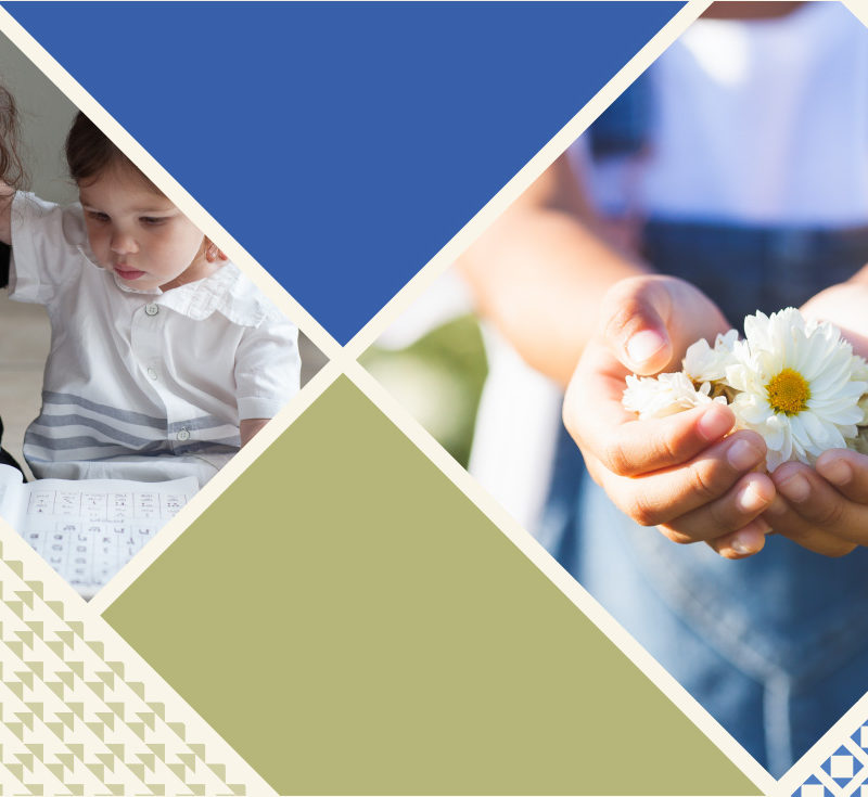 two little girls reading and one holding flowers