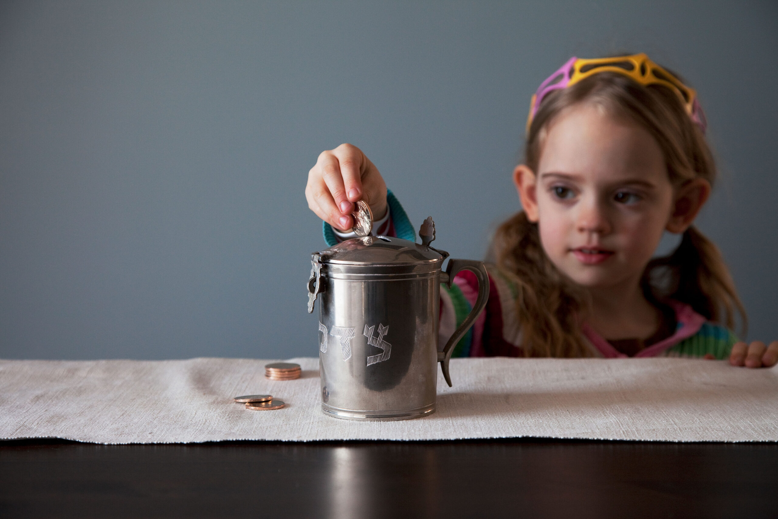 Girl gives tzedakah